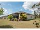 Spacious backyard featuring a screen porch, mature landscaping, and a well maintained lawn at 12308 Chaya Ct, Spring Hill, FL 34610