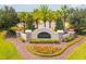 Elegant community entrance sign 'Talavera' with lush landscaping and palm trees, showcasing a welcoming and upscale neighborhood at 12308 Chaya Ct, Spring Hill, FL 34610