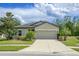 Charming single-story home featuring a well-manicured lawn and a spacious two-car garage at 12308 Chaya Ct, Spring Hill, FL 34610