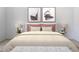 A beautifully staged bedroom with neutral tones, decorative pillows, and modern artwork at 12308 Chaya Ct, Spring Hill, FL 34610