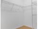 Bright walk-in closet featuring white wire shelving and neutral carpet flooring at 12308 Chaya Ct, Spring Hill, FL 34610