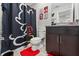 Fun bathroom with Mickey Mouse shower curtain and matching decor, creating a playful and cheerful space at 12856 French Market Dr, Riverview, FL 33579