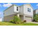 Side view of a two story home with vinyl siding, manicured lawn, and a well-maintained exterior at 12856 French Market Dr, Riverview, FL 33579