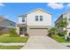 Charming two-story home with a well-manicured lawn and a two-car garage in a residential neighborhood at 12856 French Market Dr, Riverview, FL 33579