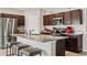 Kitchen with granite countertops, a stainless steel refrigerator, and a center island with seating at 12856 French Market Dr, Riverview, FL 33579