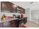 Well-equipped kitchen with stainless steel appliances and sleek dark wood cabinetry at 12856 French Market Dr, Riverview, FL 33579