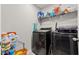 Efficient laundry room featuring modern washer and dryer, ample storage shelves, and organized cleaning supplies at 12856 French Market Dr, Riverview, FL 33579
