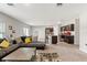 Open concept living space with dark wood kitchen cabinets and island and spacious living room with lots of light at 12856 French Market Dr, Riverview, FL 33579