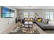 Spacious living room with a comfortable sectional sofa, stylish rug, and plenty of natural light at 12856 French Market Dr, Riverview, FL 33579