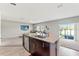Open living room showing the kitchen island with granite countertops and stainless dishwasher at 12856 French Market Dr, Riverview, FL 33579