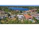 Aerial view of waterfront homes with docks on a scenic lake, lush greenery, and peaceful neighborhood ambiance at 1344 Monterey Ne Blvd, St Petersburg, FL 33704