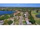 Aerial view of lakeside homes featuring lush greenery and a nearby golf course, showcasing a serene neighborhood setting at 1344 Monterey Ne Blvd, St Petersburg, FL 33704