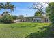 Manicured backyard with a patio and lush green lawn, with seating for relaxation and entertainment at 1344 Monterey Ne Blvd, St Petersburg, FL 33704