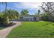 Beautiful backyard with lush green lawn, brick patio, and serene outdoor seating, perfect for relaxation and entertainment at 1344 Monterey Ne Blvd, St Petersburg, FL 33704