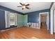 Bedroom with hardwood floors, two windows, and ceiling fan is ready for renovations at 1344 Monterey Ne Blvd, St Petersburg, FL 33704