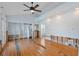 Spacious bedroom with hardwood floors, ceiling fan, and large windows, in need of some work at 1344 Monterey Ne Blvd, St Petersburg, FL 33704