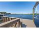 View of a wooden dock and boat lift on the serene waterfront at 1344 Monterey Ne Blvd, St Petersburg, FL 33704