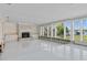 Spacious living room with fireplace, built-ins, and large windows with waterfront views at 1344 Monterey Ne Blvd, St Petersburg, FL 33704