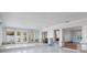 Bright living room featuring tile flooring, crown molding, recessed lights, and expansive openings, ready for renovation at 1344 Monterey Ne Blvd, St Petersburg, FL 33704