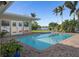 A sparkling swimming pool situated on a patio, overlooking the serene waterfront at 1344 Monterey Ne Blvd, St Petersburg, FL 33704