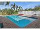 Private pool surrounded by a brick patio and lush tropical landscaping at 1344 Monterey Ne Blvd, St Petersburg, FL 33704