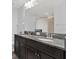 Well-lit bathroom featuring a dual-sink vanity with granite countertops and modern fixtures at 18185 Cortes Creek Blvd, Spring Hill, FL 34610