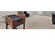 Spacious bonus room area with a foosball table, comfortable seating, and neutral carpeting at 18185 Cortes Creek Blvd, Spring Hill, FL 34610