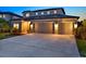 Inviting home with a three-car garage, and well lit at twilight at 18185 Cortes Creek Blvd, Spring Hill, FL 34610