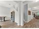 Bright foyer with wood-look tile, staircase, and decorative shelving unit at 18185 Cortes Creek Blvd, Spring Hill, FL 34610