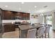 Elegant kitchen with dark wood cabinetry, a large island, and stainless appliances at 18185 Cortes Creek Blvd, Spring Hill, FL 34610