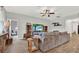 Cozy living room with plush sofa, wood-look tile, and entertainment center at 18185 Cortes Creek Blvd, Spring Hill, FL 34610