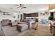 Open-concept living room with dark wood cabinets, plush sofa, and breakfast nook at 18185 Cortes Creek Blvd, Spring Hill, FL 34610