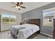 Bright main bedroom with large windows, neutral paint, and wood-look tile flooring at 18185 Cortes Creek Blvd, Spring Hill, FL 34610