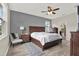 Spacious main bedroom with wood-look tile flooring, a ceiling fan, and neutral decor at 18185 Cortes Creek Blvd, Spring Hill, FL 34610