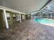 Spacious outdoor back patio with screened enclosure, overlooking a large in-ground pool at 18724 Geraci Rd, Lutz, FL 33548