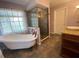 Elegant bathroom with a standalone tub, glass shower, and stylish vanity at 18724 Geraci Rd, Lutz, FL 33548