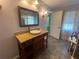 Bathroom vanity with vessel sink, granite countertop, and stone tile flooring at 18724 Geraci Rd, Lutz, FL 33548