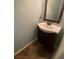 Powder room with pedestal sink, bronze mirror, and natural light at 18724 Geraci Rd, Lutz, FL 33548