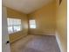 Empty carpeted room with natural light from windows, ready for personalization at 18724 Geraci Rd, Lutz, FL 33548