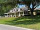 Spacious single-Gathering house with a wraparound porch, perfect for relaxing outdoors at 18724 Geraci Rd, Lutz, FL 33548