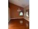 Spacious room featuring hardwood floors, high ceilings, and a decorative chandelier at 18724 Geraci Rd, Lutz, FL 33548