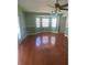 Living room with hardwood floors, large windows, and a ceiling fan at 18724 Geraci Rd, Lutz, FL 33548