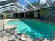 Screened-in swimming pool with brick paver deck and spacious backyard at 18724 Geraci Rd, Lutz, FL 33548