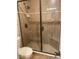 Shower with glass door, tiled surround, and built-in bench in updated bathroom at 18724 Geraci Rd, Lutz, FL 33548