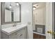 Stylish bathroom featuring a modern vanity and sink, adjacent to a laundry area, creating a convenient space at 1900 59Th N Ave # 108, St Petersburg, FL 33714