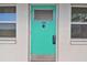 Charming teal front door with number 108, flanked by windows, creating a welcoming entrance at 1900 59Th N Ave # 108, St Petersburg, FL 33714