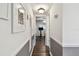 Hallway with painted wainscoting leading to living area with view of bicycle at 1900 59Th N Ave # 108, St Petersburg, FL 33714