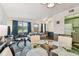 Bright living space features a round glass table, comfortable seating, and scenic views from the large windows at 1900 59Th N Ave # 108, St Petersburg, FL 33714