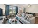 Bright living room with large sofa, glass coffee table, and natural light from the windows at 1900 59Th N Ave # 108, St Petersburg, FL 33714