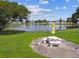 Picturesque pond view with seating area, green lawn and trees, creating a peaceful outdoor retreat at 1900 59Th N Ave # 108, St Petersburg, FL 33714